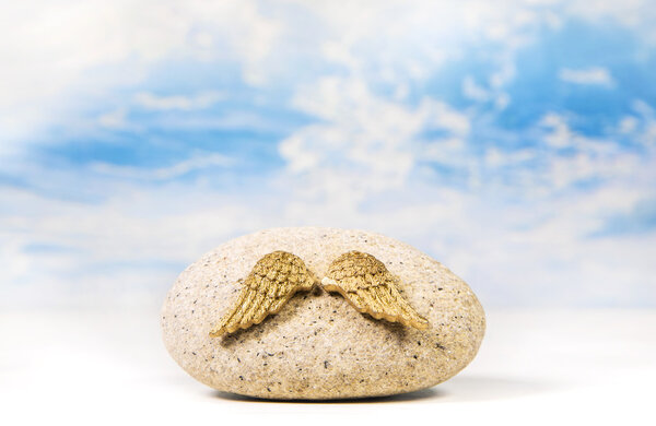 Angel wings on a stone. Idea for a concept with dreams and wishe