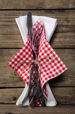 Cutlery with knife and fork plus a napkin in red white checked c
