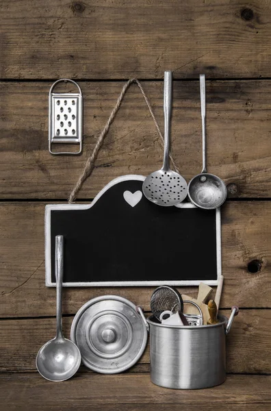 Wooden vintage kitchen background with old kitchenware, blackboa ロイヤリティフリーのストック画像