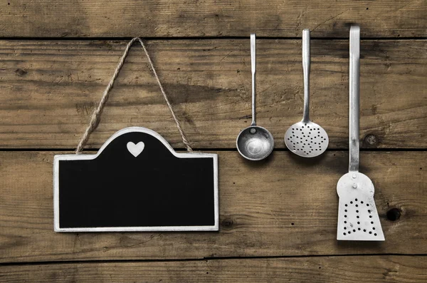 Wooden old kitchen background with old kitchenware, blackboard a — Stock Image Wooden old kitchen background with old kitchenware, blackboard a Royalty Free Stock Images