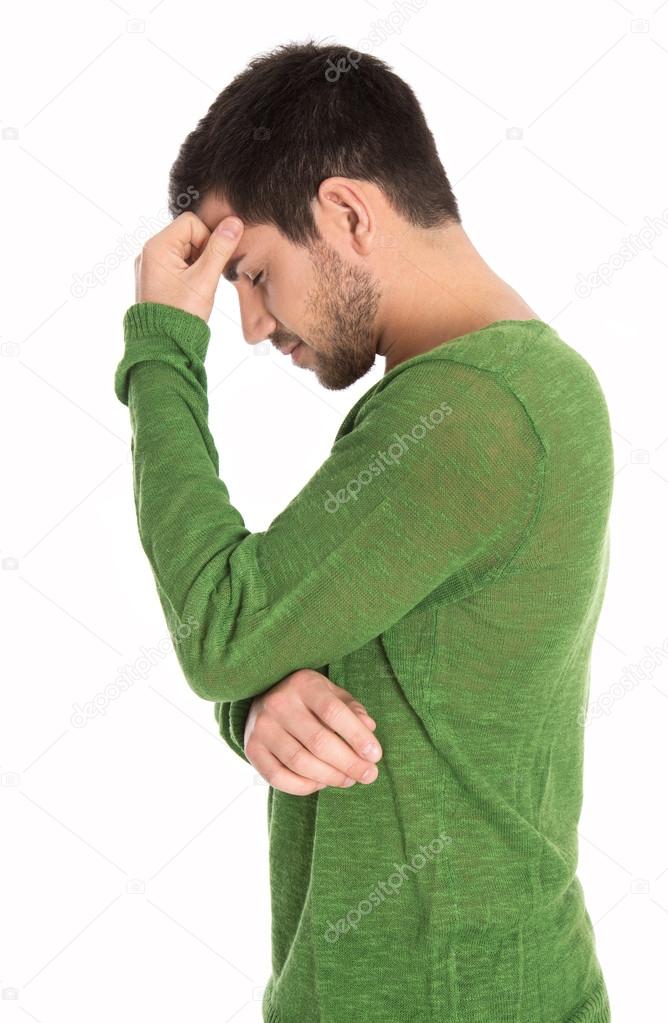 Pensive or depressive isolated man in green pullover.