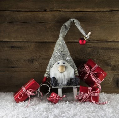 Imp santa with red christmas presents in rustic country style.