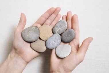 Woman hands holding stones. Concept for balance, combination, li