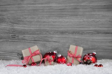 Christmas presents wrapped in paper decorated with red balls on 