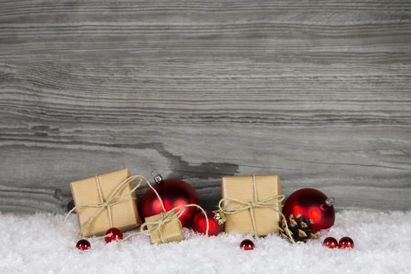 Christmas presents wrapped in paper decorated with red balls on Stockbild