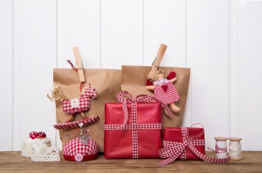 Christmas presents wrapped in paper bags with red white checked 