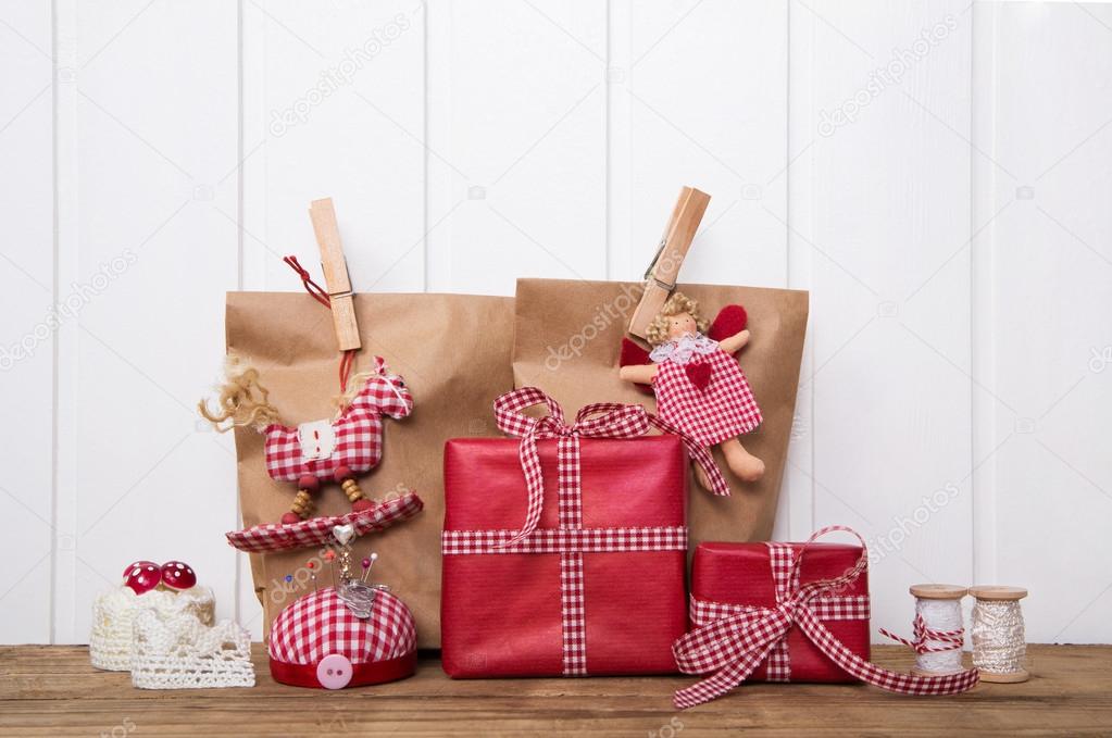Christmas presents wrapped in paper bags with red white checked 