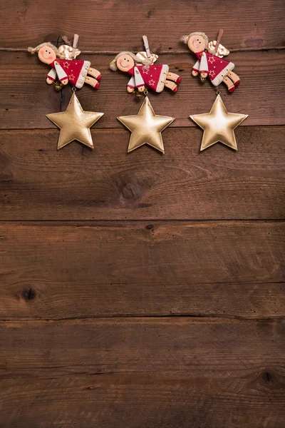 Three red and golden Christmas angels on old wooden background f Royalty Free Stock Obrázky