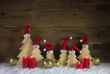 Four red burning advent candle for christmas decoration on old w