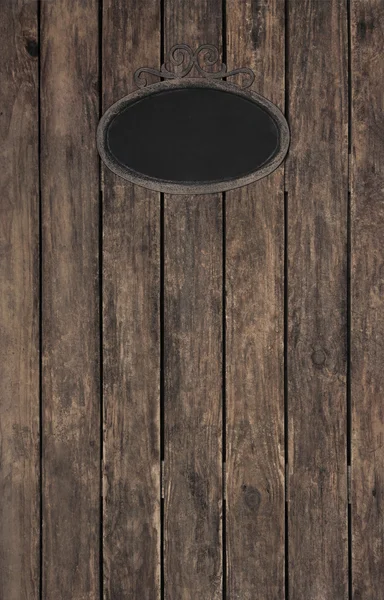 Old wooden dark brown patterned background with a black ancient — Stok fotoğraf