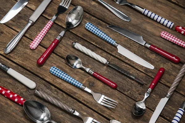 Old wooden background with a collection of cutlery composed with — Stock Photo, Image