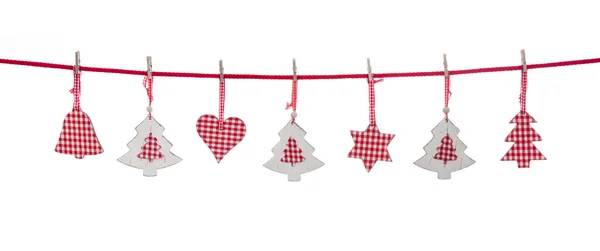 Isolated red and white christmas decoration hanging on a line. Stockbild