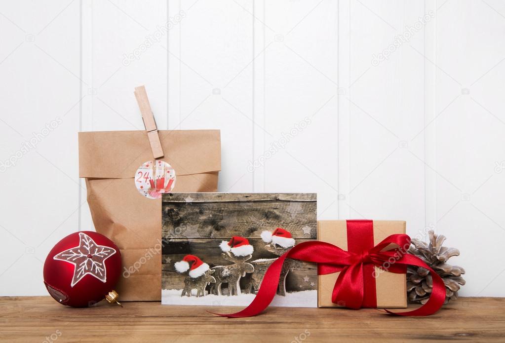 Handmade christmas presents wrapped in paper with red ribbon and