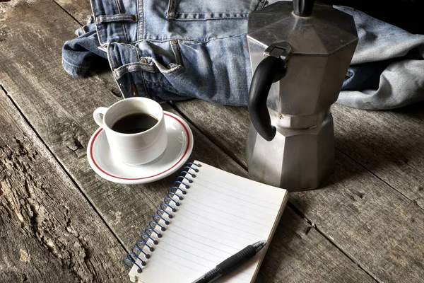 Espresso coffee, espresso maker, notepad and dirty jeans — Stock Photo, Image