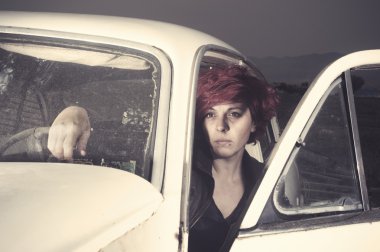 Woman inside an old car