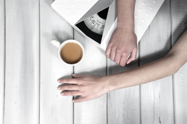 Hands close up of a woman lying on scale — Stock Photo, Image