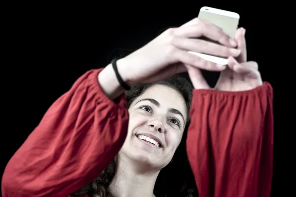 Young female holding a smartphone — Stock Photo, Image