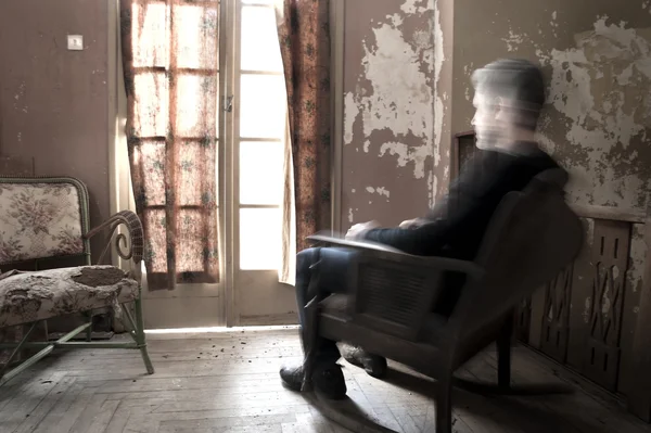 Man sitting on rocking chair Stock Photo