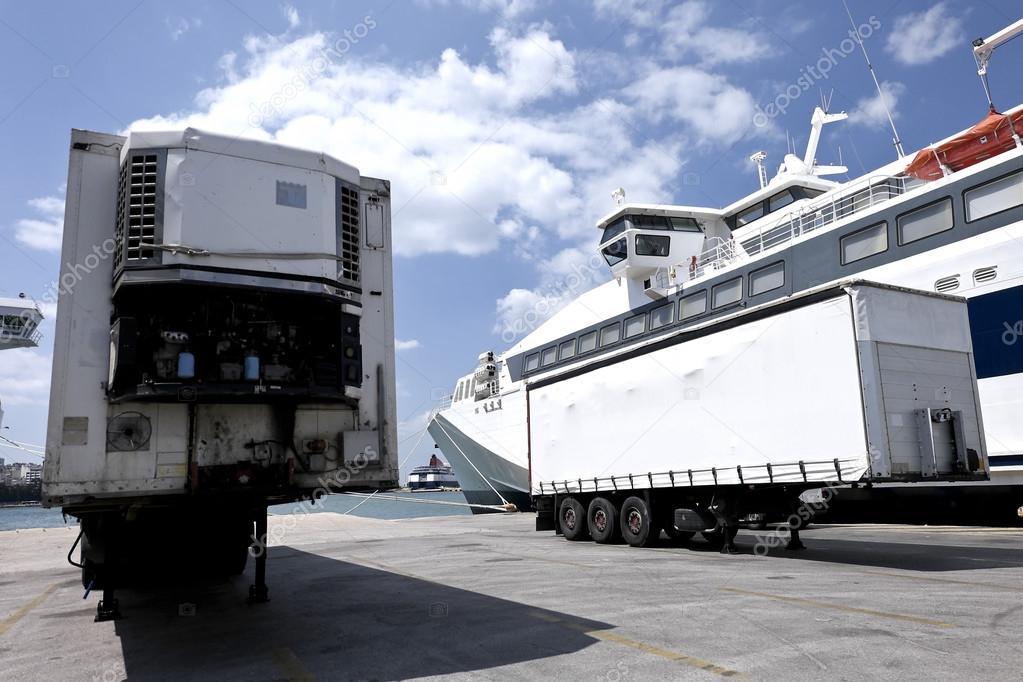 Cargo trailers near docked ship