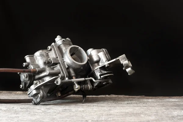 Carburetor on wooden surface — 图库照片