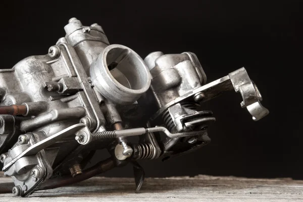 Carburetor on wooden surface — 图库照片