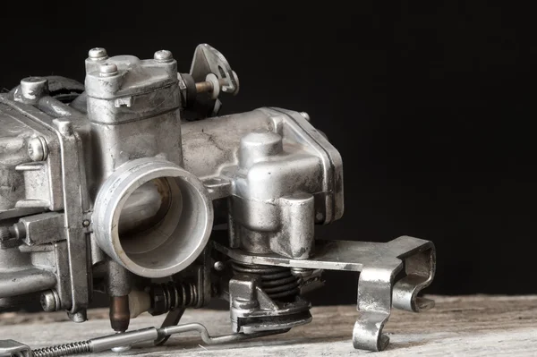 Carburetor on wooden surface — ストック写真