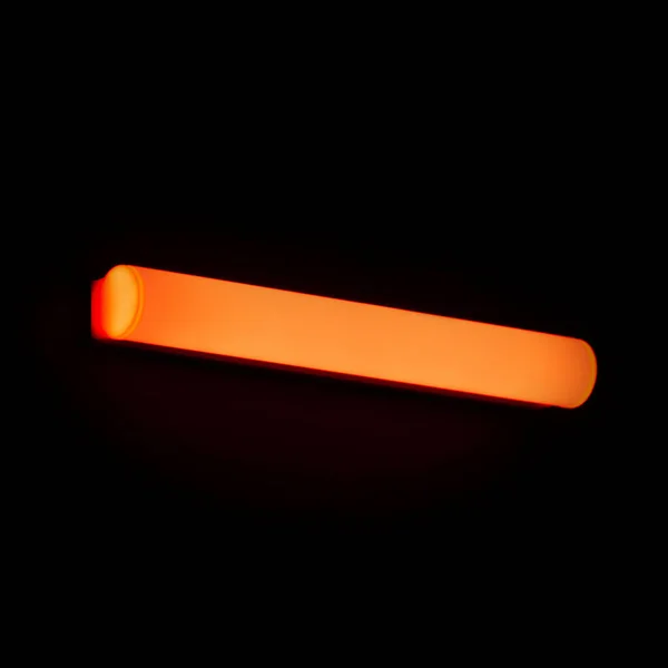 Red led decorative light bar on black background.