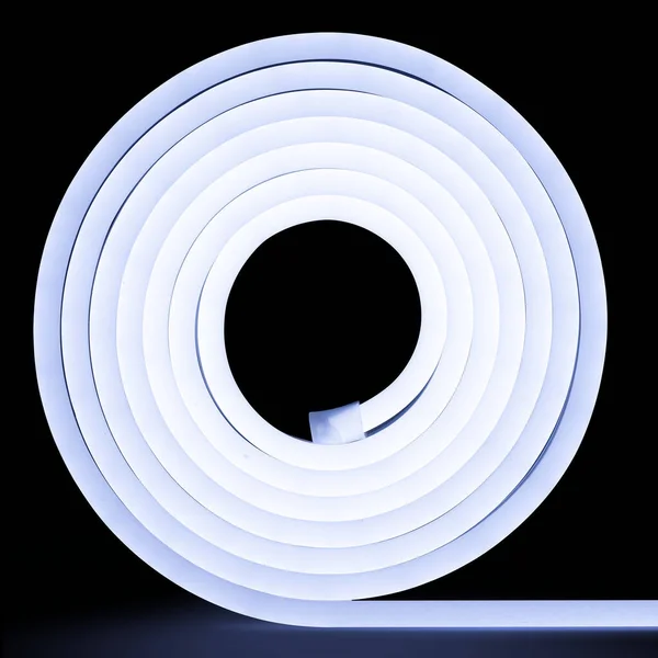 Cold white glowing LED neon flex strip on black dark background.