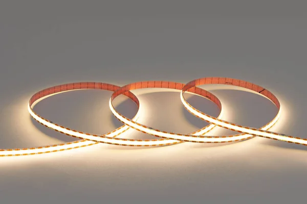 Glowing led strip in roll on white background.