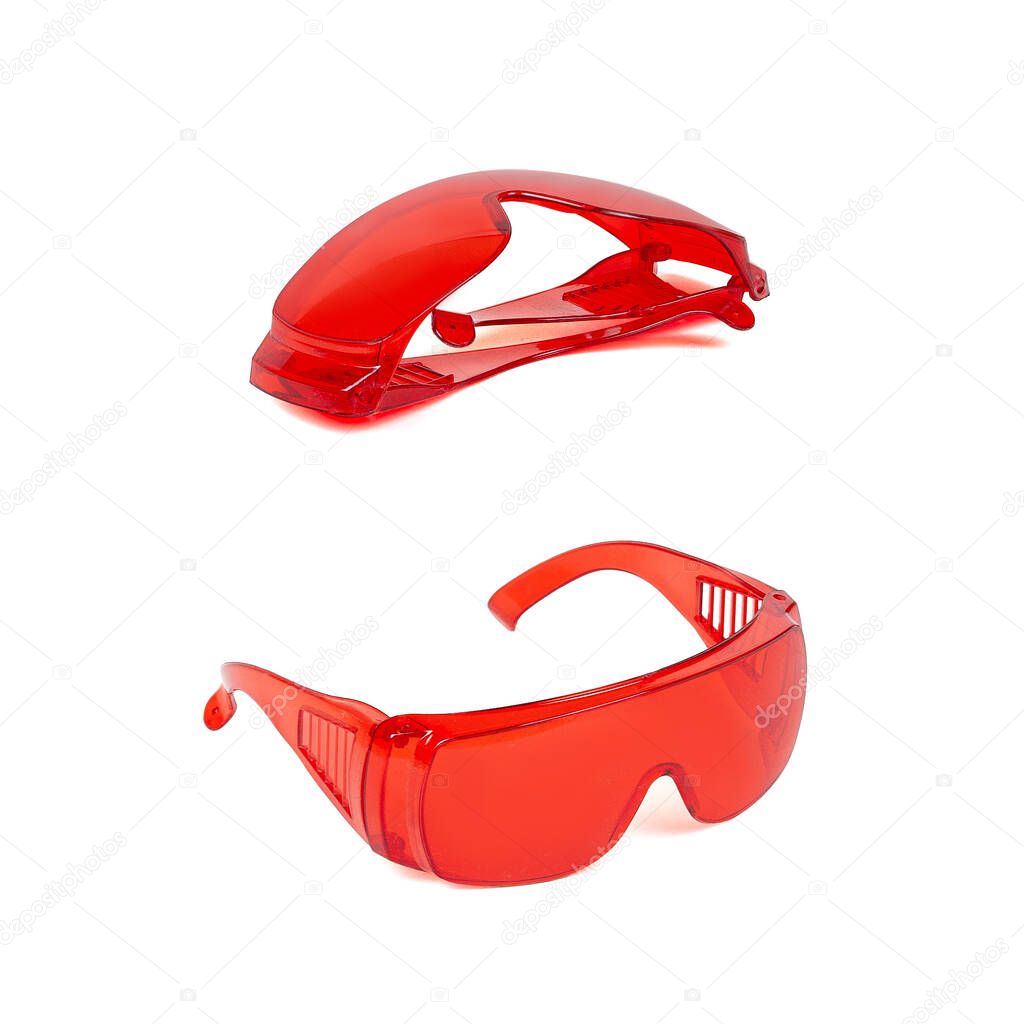 Red ultraviolet protective safety glasses isolated on white background.