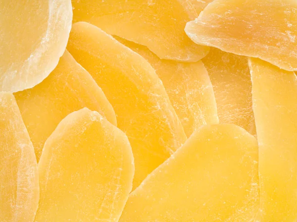 Dried mango background. Candied slices of mango fruit close-up.