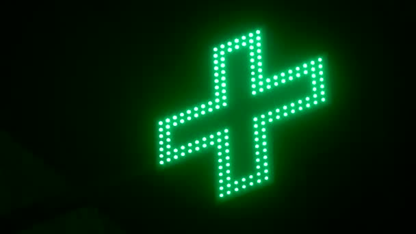 Flashing Green Cross on a Black Background — ストック動画