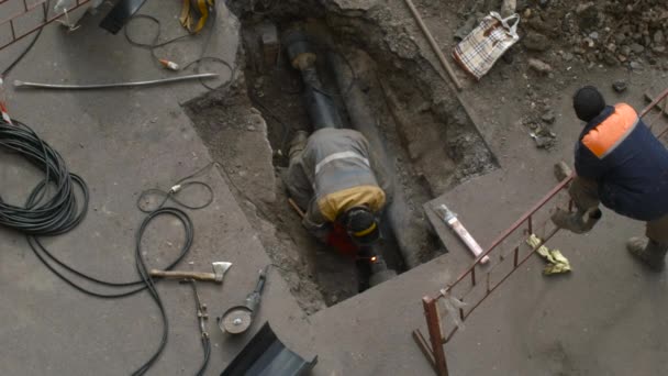 Welder Repairing a Pipe in a Hole — Stock Video