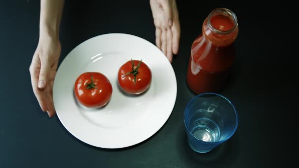Hand Turn Plate With Two Tomatoes on a Table