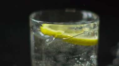 Round Slice of Lemon Drops in a Glass of Water