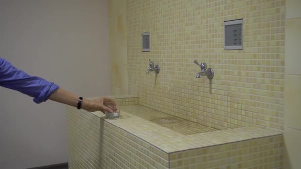 Hand Puts the Glass on the Tiled Sink — Stock Video