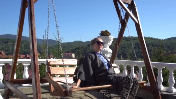 Young Woman Resting on a Wooden Swing — 비디오