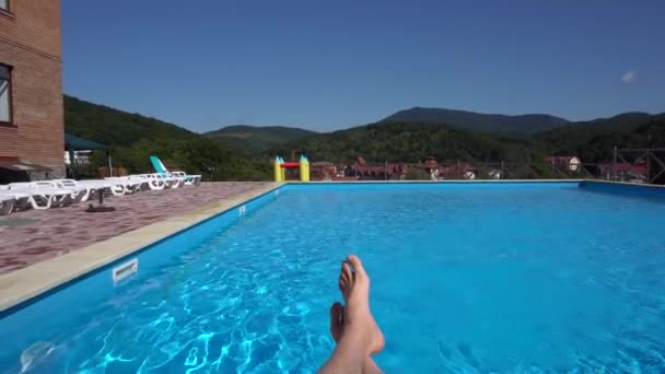 Person's Legs Lying Near the Well-Equipped Pool — Stock Video