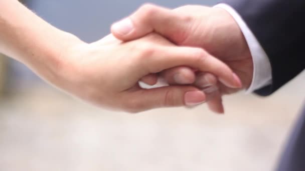 Detail of two lovers joining hands — Stock Video