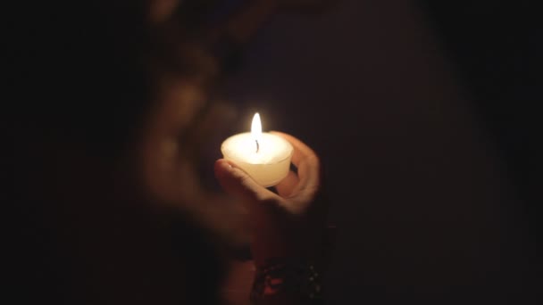 Χέρι κρατώντας ένα αναμμένο κερί — Αρχείο Βίντεο