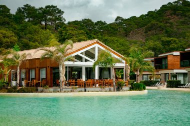 Yüzmek ve dinlenmek için rahat bir yüzme havuzu, otelin mavi suyuyla, bir yaz günü.