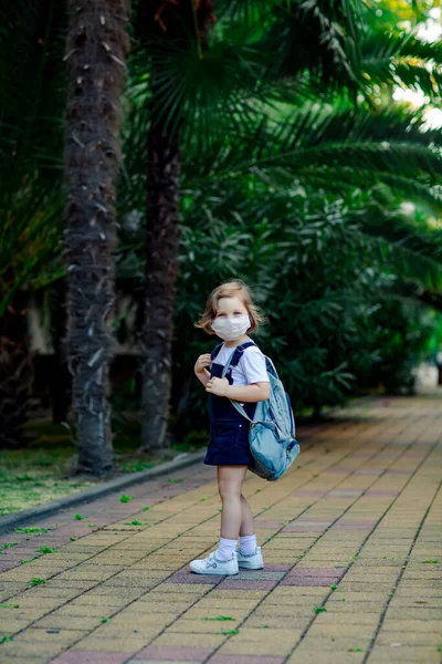 Little Girl Schoolgirl Goes School Park Denim Backpack Medical Mask — Stock fotografie