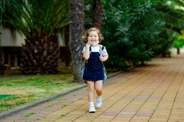 Little Girl Schoolgirl Goes School Park Denim Backpack Medical Mask — Stock fotografie