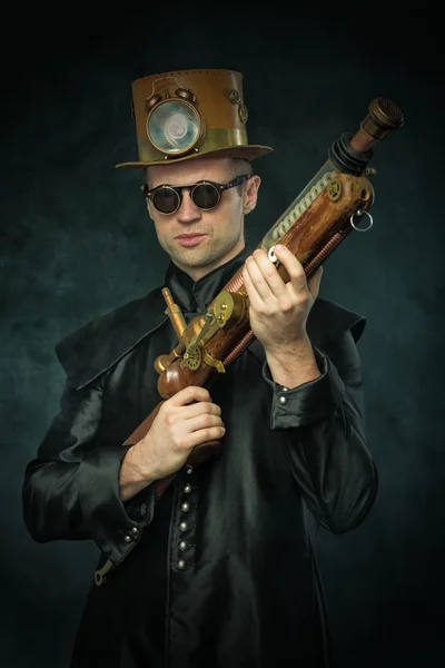 Steampunk man in een hoed met pistool — Stockfoto