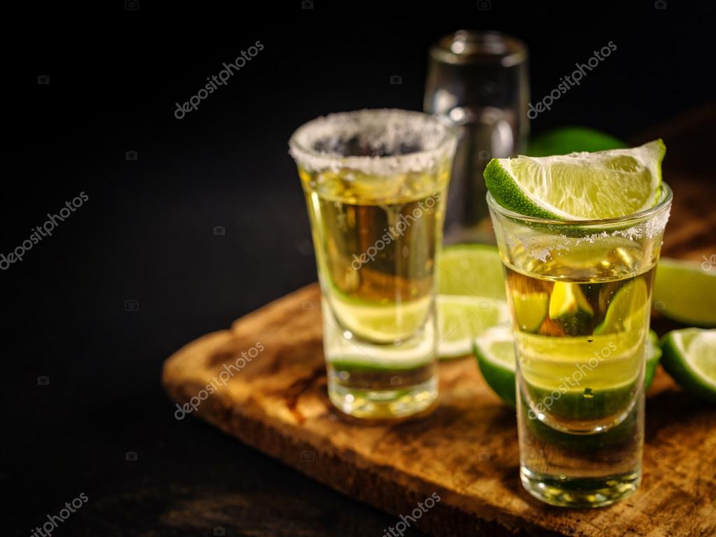 Mexican Gold Tequila with lime and salt on wooden table — Stock Photo ©  fotoatelie #116926902, image size:1024x768