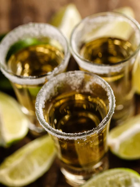 Mexican Gold Tequila with lime and salt on wooden table — Stock Photo, Image