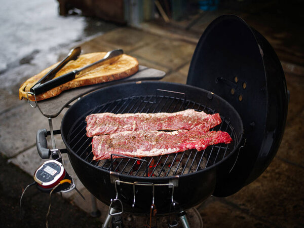 Hanging tender or onglet steak of beef on the grill. Grilling meat. BBQ.