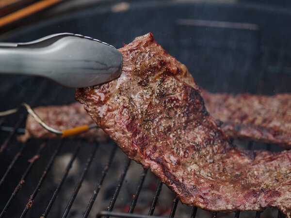 Hanging tender or onglet steak of beef on the grill. Grilling meat. BBQ.