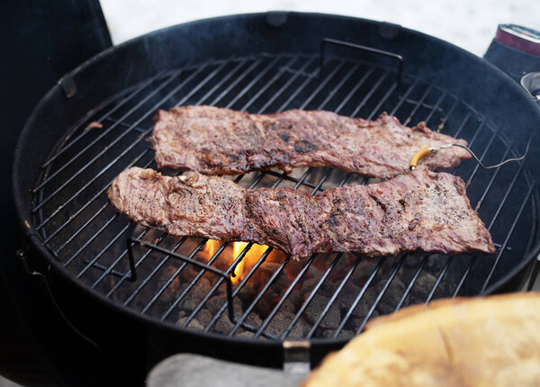 Hanging tender or onglet steak of beef on the grill. Grilling meat. BBQ.
