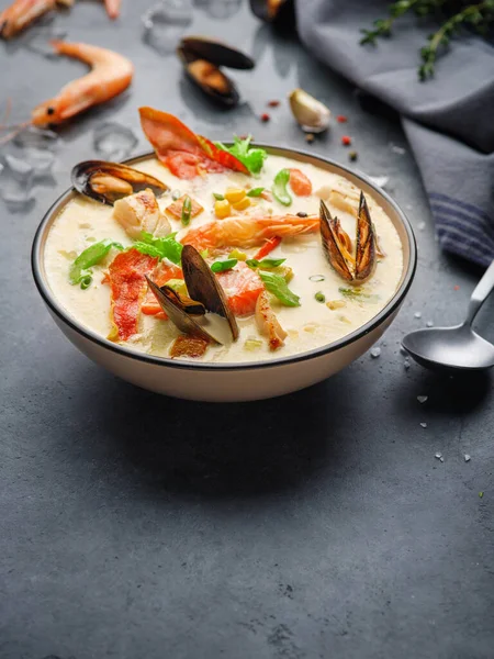 New England clam chowder, occasionally referred to as Boston or Boston-style Clam Chowder. Creamy soup with shrimp, corn, bacon and mussels.